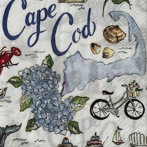 May include: White paper napkin with a Cape Cod theme. Features illustrations of a lighthouse, sailboats, a bicycle, hydrangeas, blueberries, and a map of Cape Cod. The words "Cape Cod" are written in blue script.