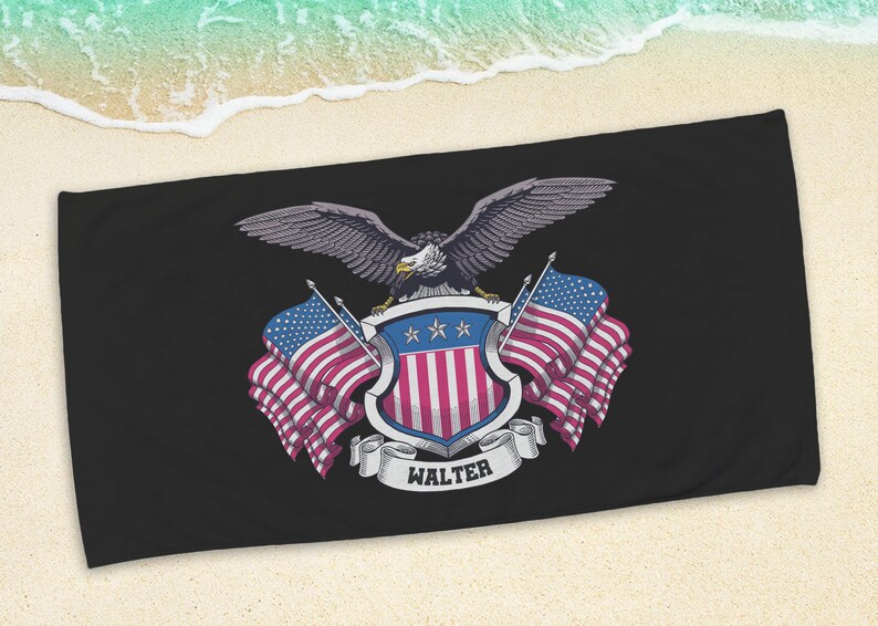 May include: Black beach towel featuring a patriotic design. The design includes a detailed illustration of an eagle with outstretched wings, a shield with red and white stripes, and American flags. The name "WALTER" is displayed on a banner.
