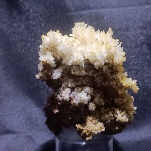 Gypsum on limonite from the ancient mines of Libiola, Italy.