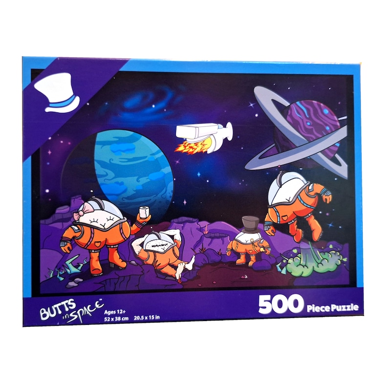 May include: A 500 piece jigsaw puzzle featuring a cartoon illustration of astronauts in space. The puzzle box has a purple background with the words "Butts in Space" and a cartoon top hat. The puzzle is for ages 12 and up and measures 20.5 x 15 inches.