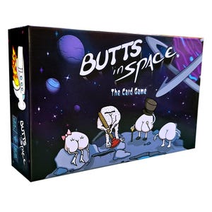 May include: A boxed card game titled "BUTTS in SPACE" features cartoon butts in space suits and hats on a planet surface. The box has a space-themed background with planets and stars. The game's title is in white, with the words "The Card Game" below.