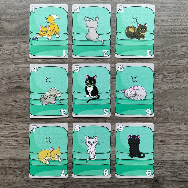 May include: Nine green cards with a number on each card. Each card has a picture of a cat sitting in a chair. The cats are different colors and have different poses.