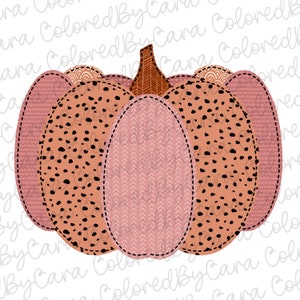 May include: A pink and orange pumpkin with a black and white polka dot pattern. The pumpkin is made of fabric and has a stitched seam around the edges.
