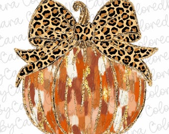 May include: A brown and orange pumpkin with a gold glitter finish and a large leopard print bow. The pumpkin has a white and brown abstract pattern.