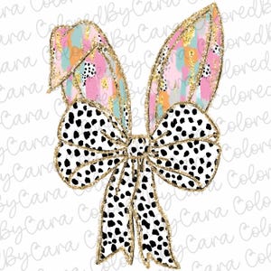 May include: A decorative Easter bunny ears and bow design. The ears feature a colorful abstract pattern with gold glitter accents. The bow is white with black spots and gold glitter trim. The design is on a white background.
