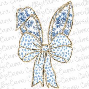 May include: A blue and white bow with gold glitter accents. The bow is tied in a knot and has a floral pattern.