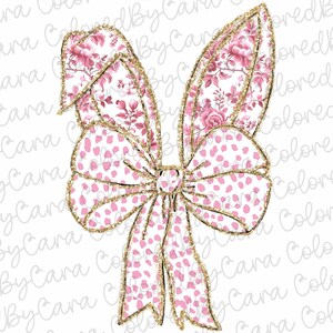 May include: A large pink bow with a white background and gold glitter accents. The bow is made of two different fabrics, one with a floral pattern and the other with a polka dot pattern.