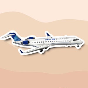 May include: A sticker of a white airplane with blue accents and the text "UNITED EXPRESS". The plane has two engines and a tail fin with a blue and white design. The sticker is on a light brown background.