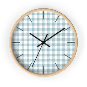 May include: A round wall clock with a light blue and white gingham pattern. The clock has black hands and a wooden frame.