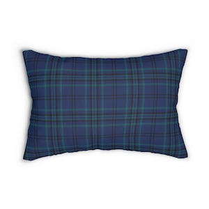 May include: A rectangular pillow with a blue plaid pattern. The plaid design features intersecting lines in shades of blue, teal, and black. The pillow is a decorative item, likely for a bed or sofa.