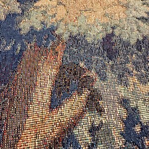 May include: Close-up of a woven textile with a textured surface. The pattern features a blend of colors, including shades of blue, brown, and beige. The weave creates a detailed, abstract design, suitable for home decor or fashion.