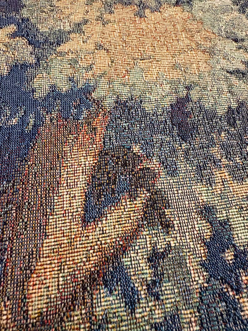 May include: Close-up of a woven textile with a textured surface. The pattern features a blend of colors, including shades of blue, brown, and beige. The weave creates a detailed, abstract design, suitable for home decor or fashion.