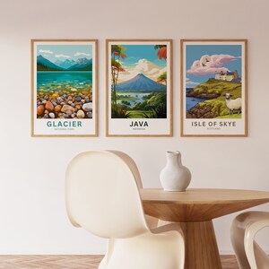 May include: Three framed travel posters. The first depicts Glacier National Park with a lake and mountains. The second shows a volcano in Java, Indonesia. The third features the Isle of Skye, Scotland, with a sheep.