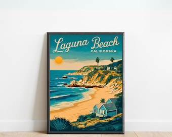 May include: A framed art print featuring a coastal scene of Laguna Beach, California. The artwork depicts a sunny day with a blue ocean, sandy beach, and a small blue house. The text "Laguna Beach CALIFORNIA" is at the top.