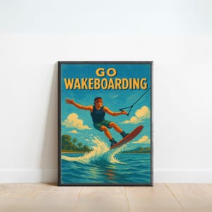 May include: A framed poster with a vintage style illustration of a person wakeboarding. The poster has the words "GO WAKEBOARDING" in yellow and white. The person is wearing a red headband, black tank top, and green shorts. The background shows a blue sky, water, and clouds.
