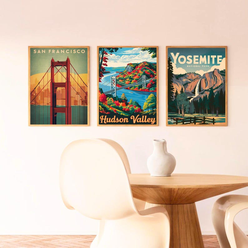 May include: Three vintage travel posters with a wood frame. The poster on the left shows the Golden Gate Bridge in San Francisco. The middle poster shows a bridge over a river with fall foliage and the text "Hudson Valley". The poster on the right shows a waterfall in Yosemite National Park.