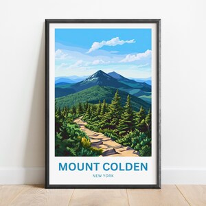 May include: A framed print featuring a scenic view of Mount Colden in New York. The artwork depicts a mountain landscape with a hiking trail winding through a forest of green trees, under a blue sky with fluffy clouds. The text "MOUNT COLDEN NEW YORK" is at the bottom.