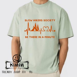 Slow Hikers Society Be There In A Minute PNG hiking humor outdoor lovers png trail walking funny nature PNG Hiking Backpack Group Event 2026
