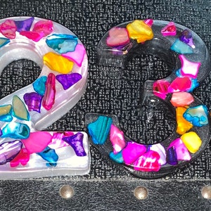 May include: A set of four resin house numbers, each featuring a unique design of colorful mosaic pieces. The numbers are 1, 2, 3, and 4.