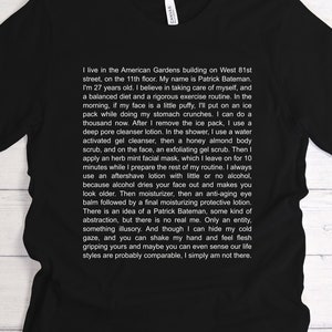 May include: Black V-neck t-shirt with white text describing a daily routine. The text includes the name Patrick Bateman and details a meticulous skincare regimen.