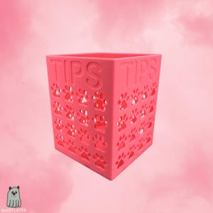 Könnte beinhalten: Ein Set aus drei Keramikbechern mit gesprenkelter, matter Oberfläche. Die Becher sind in Creme-, Hellgrau- und Dunkelgrautönen gehalten. Jeder Becher hat ein schlichtes, minimalistisches Design, ideal für Kaffee oder Tee.