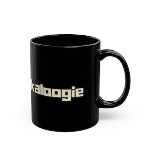 May include: A black ceramic mug with a white inscription that reads "kaloogie".