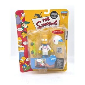 May include: A packaged "World of Springfield" interactive figure of Bart Simpson as Daredevil. The figure is yellow with a white outfit, blue shoes, and a white helmet with a blue visor. Includes a green skateboard and a small image of Bart.