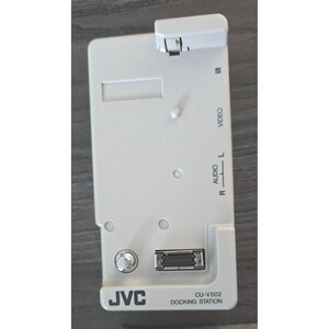 May include: A white JVC CU-V502 docking station with a silver port, audio and video inputs, and a small, adjustable top piece. The docking station has the JVC logo and "DOCKING STATION" printed on the bottom.