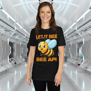 May include: Black t-shirt featuring a cartoon bee and the text "Let it bee bee api".
