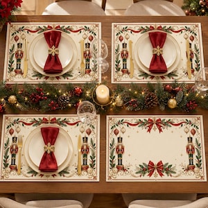 May include: Four rectangular placemats featuring a cream background with a border of red ribbons, green pine branches, and nutcracker figures. Each placemat includes a white plate, a deep red napkin, a gold snowflake napkin ring, and gold cutlery.