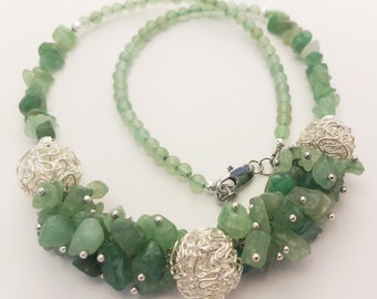 Beads made of crumbs of natural stone and silver-like balls