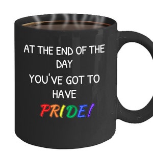 May include: Black coffee mug with the text "At the end of the day you've got to have PRIDE!" in white lettering. The word "PRIDE" is in rainbow colors.