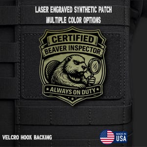 May include: A laser-engraved synthetic patch with the text "CERTIFIED BEAVER INSPECTOR" and a beaver illustration holding a magnifying glass. The patch also includes the text "ALWAYS ON DUTY" and "VELCRO HOOK BACKING". Made in the USA.
