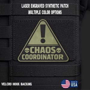 May include: A triangular olive green synthetic patch with a black border and black text reading CHAOS COORDINATOR. The patch features an exclamation point icon and two small skull icons. The text LASER ENGRAVED SYNTHETIC PATCH, MULTIPLE COLOR OPTIONS, and VELCRO HOOK BACKING is visible.