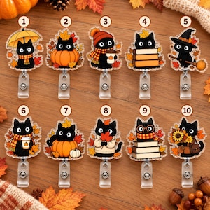 May include: Ten acrylic badge reels featuring black cat illustrations with autumn themes, including pumpkins, orange scarves, books, sunflowers, and hats, each numbered one through ten and attached to a retractable clip mechanism.