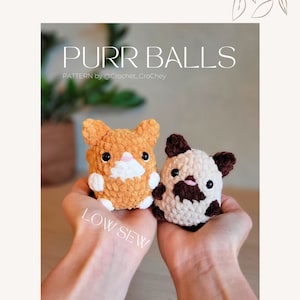 May include: Two crocheted stuffed animals in the shape of cats, one orange and one brown and white, are held in the palms of a person's hands. The text "PURR BALLS" and "LOW SEW" are visible in the image.