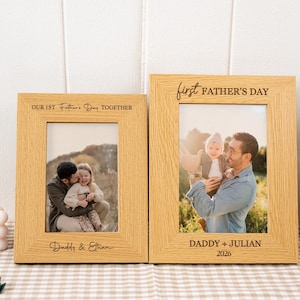 May include: Two wooden photo frames with family photos. The left frame reads "Our 1st Father's Day Together" and "Daddy & Ethan". The right frame reads "First Father's Day" and "Daddy + Julian 2026".
