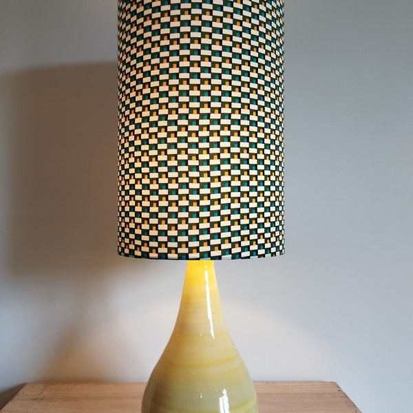 vintage style lamp with a yellow ceramic base and a multi-colored lampshade to decorate your interior with elegance