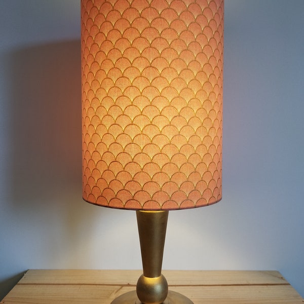 table lamp with a gold wooden foot and a shade in coral and gold cotton with patterns to decorate your interior with elegance