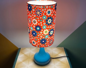 Vintage style lamp with a blue base and a colorful orange patterned lampshade to decorate your interior with elegance