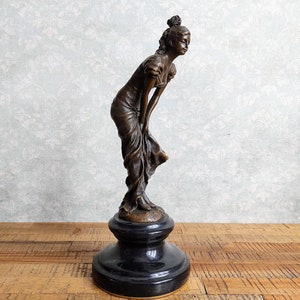 Female in a Long Draped Dress Slightly Bending Over - Classic Art Deco Bronze Sculpture of a Woman on a Marble Base