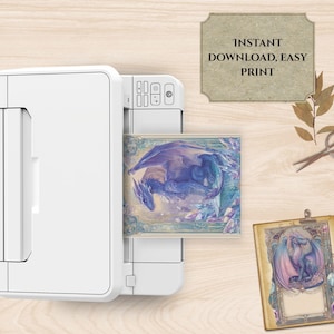 May include: A white printer is shown printing a fantasy art print featuring a blue dragon. The print is labeled "INSTANT DOWNLOAD, EASY PRINT". A second print with a dragon is visible on the right.