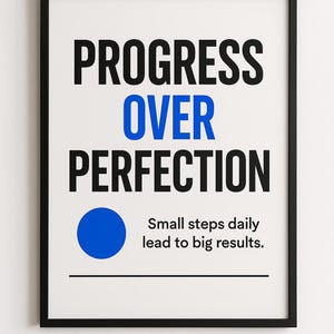 May include: A framed print with the words "PROGRESS OVER PERFECTION" in black and blue. Below the text is a blue circle and the phrase "Small steps daily lead to big results."