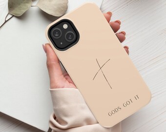 May include: A beige phone case with a black cross and the text "GODS GOT IT" printed on it.