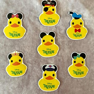 May include: Six yellow rubber ducky stickers with different Disney character hats. Each ducky has the words "Disney Treasure" printed on its chest.