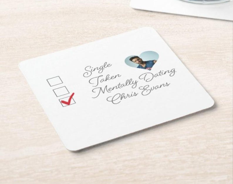 May include: A white coaster with a checklist and a heart-shaped cutout with a photo of Chris Evans. The checklist has three options: Single, Taken, Mentally Dating Chris Evans. The box next to "Mentally Dating Chris Evans" is checked.