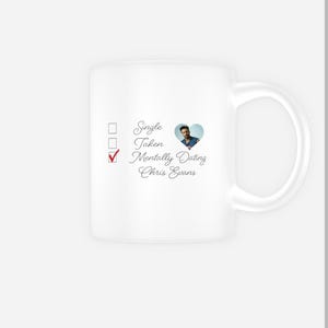 May include: White ceramic mug with a checklist and a heart featuring a photo of Chris Evans. The checklist has three options: Single, Taken, Mentally Dating Chris Evans. The box next to Mentally Dating Chris Evans is ticked.