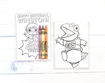 May include: Two rectangular coloring sheets and three Crayola crayons. The left sheet features a superhero character with the text "HAPPY BIRTHDAY, WINSTON!" and "RYAN'S WORLD". The right sheet shows a cartoon dinosaur with the name "GUS" on its shirt.
