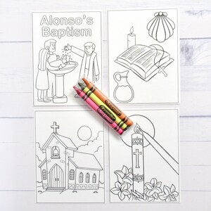 May include: Four black and white coloring pages with the title "Alonso's Baptism" at the top of the first page. The pages depict a baptism, a church, a bible, a candle, and a shell. Three crayons are included.
