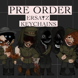 May include: A set of four illustrated character keychains featuring figures in military-style uniforms. The text PRE ORDER ERSATZ KEYCHAINS is displayed at the top. The characters have stylized, distorted features, including dark masks, exposed teeth, and animal-like traits, rendered in a dark, muted color palette.